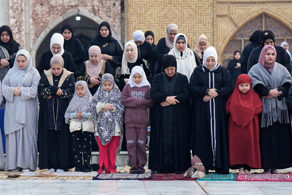 Muslims offer Eid al-Fitr prayers at the Abdul-Qadir al-Gailani mosque in Baghdad, Iraq, Friday, March 20, 2026. (AP Photo/Hadi Mizban)