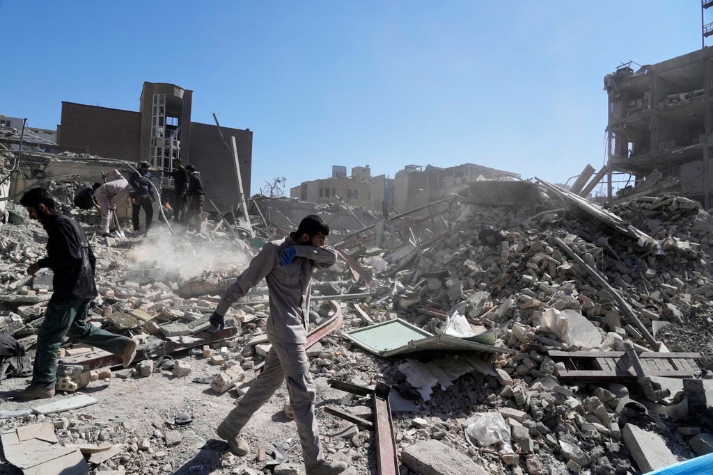 A group of men inspect the ruins of a police station struck Monday amid the U.S.–Israeli military campaign in Tehran, Iran, Tuesday, March 3, 2026. (AP Photo/Vahid Salemi)