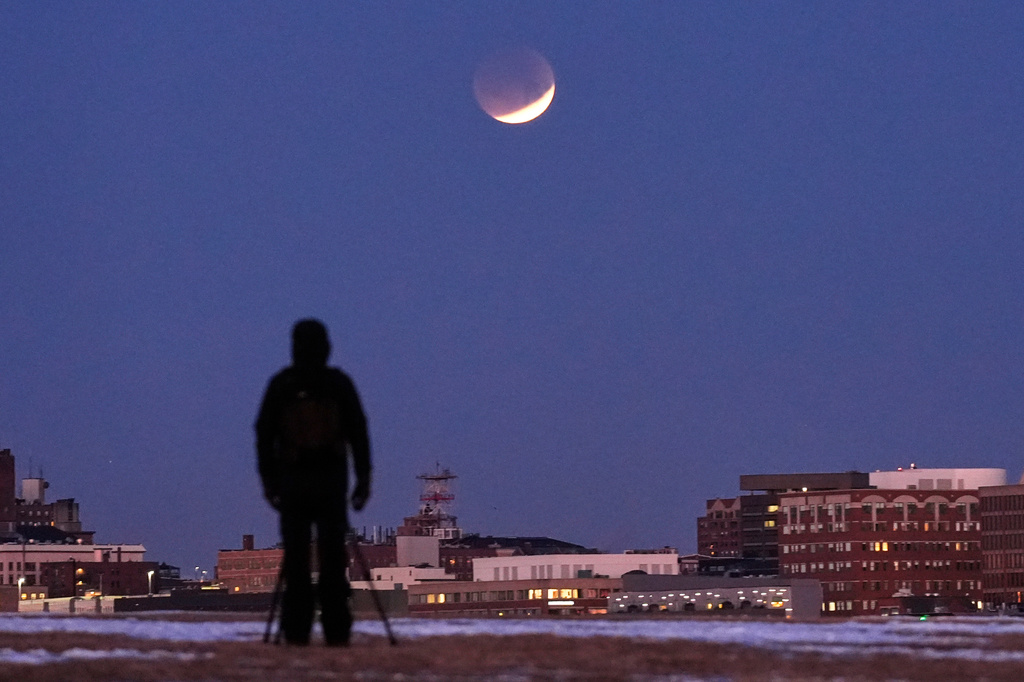 FILE - A man views the lunar eclipse, Tuesday, March 3, 2026, in South Portland, Maine. (AP Photo/Robert F. Bukaty, File)