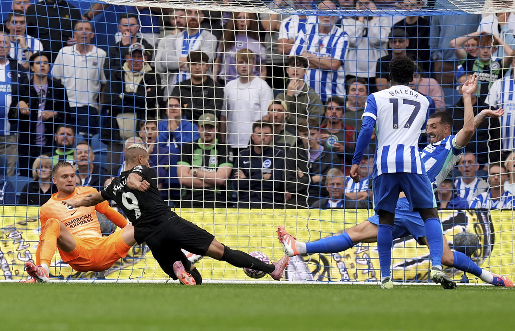 Tottenham Hotspur's Richarlison, second left, scores his sides first goal during English Premier League soccer match between Brighton and Tottenham Hotspur match at the American Express Stadium in Brighton, England on Saturday Sept. 20, 2025. (Gareth Fuller/PA via AP)