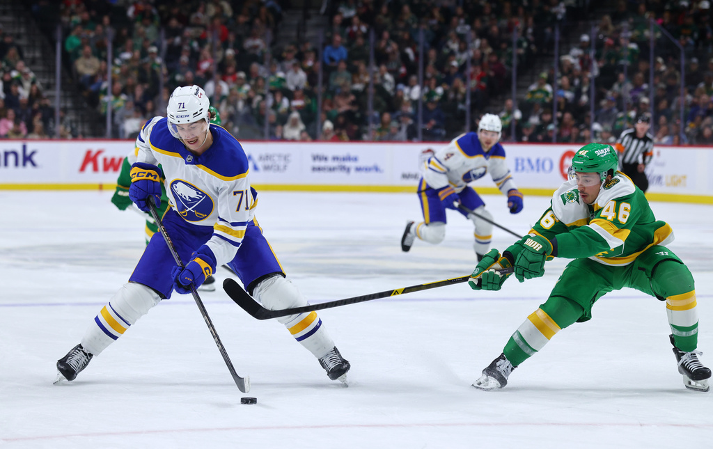 Buffalo Sabres center Ryan McLeod (71) handles the puck while Minnesota Wild defenseman Jared Spurgeon (46) defends during the second period of an NHL hockey game Saturday, Nov. 29, 2025, in St. Paul, Minn. (AP Photo/Adam Bettcher)