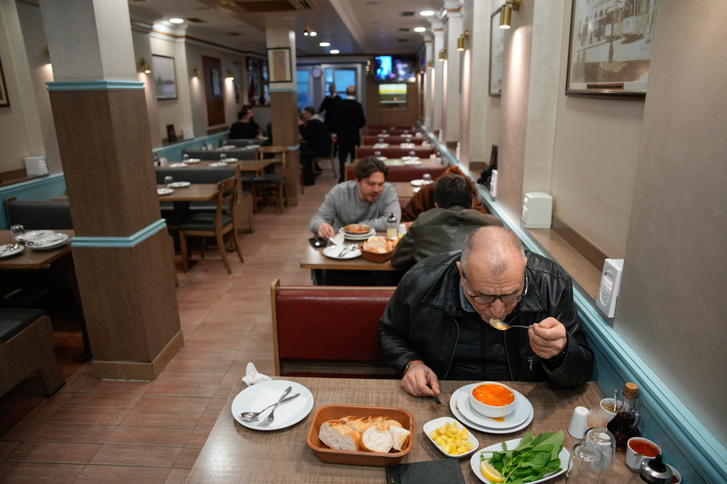 People eat traditional tripe soup, known as "iskembe" in Turkish and "patsas" in Greek, in a restaurant in Istanbul, Turkey, Friday, March 27, 2026. (AP Photo/Emrah Gurel)