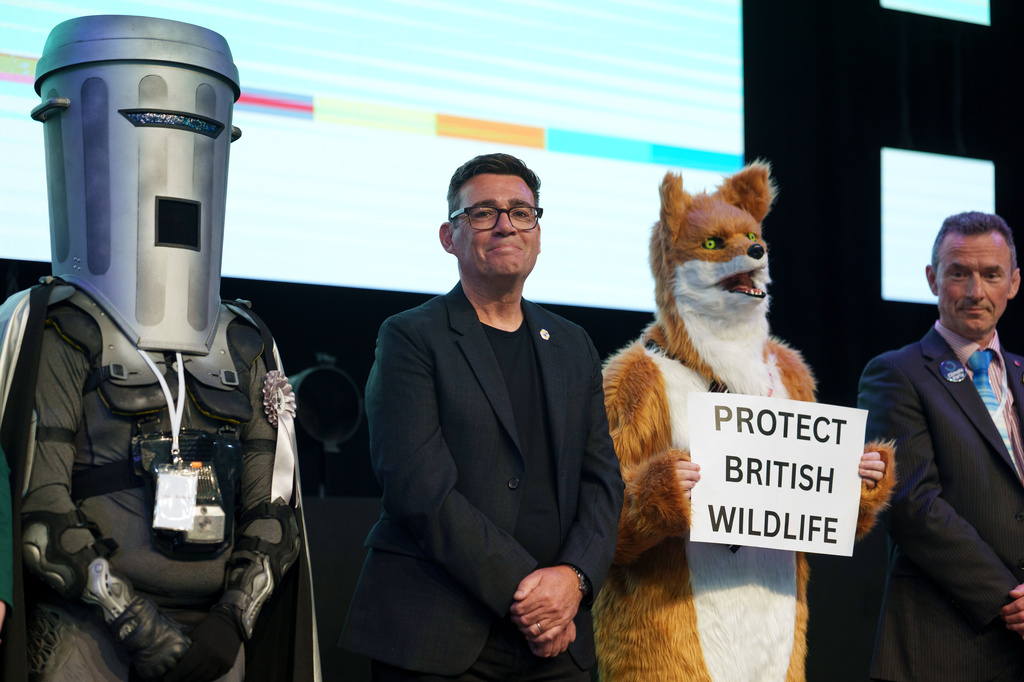 Labour party's Andy Burnham stands beside candidate Count Binface, left, and a candidate for Protect British Wildlife after winning the Makerfield by-election, paving the way for a leadership challenge against Prime Minister Sir Keir Starmer. in Wigan, England, Friday, June 19, 2026.(AP Photo/Jon Super)