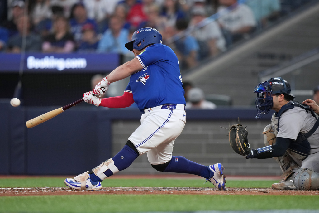 Toronto Blue Jays' Alejandro Kirk (30) hits a home run during the eighth inning against the New York Yankee in Game 1 of baseball's American League Division Series, Saturday, Oct. 4, 2025, in Toronto. (Nathan Denette/The Canadian Press via AP)