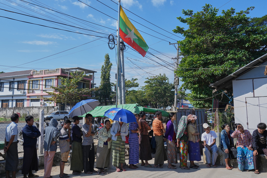 Voters line up to cast their ballots at a polling station in Naypyitaw, Myanmar, Sunday, Dec. 28, 2025. (AP Photo/Aung Shine Oo)