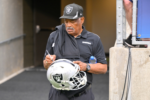 FILE - Former Oakland Raiders safety George Atkinson signs his autograph before the NFL football exhibition Hall of Fame Game between the Las Vegas Raiders and the Jacksonville Jaguars, Aug. 4, 2022, in Canton, Ohio. (AP Photo/David Richard, file) FILE - Former Oakland Raiders safety George Atkinson signs his autograph before the NFL football exhibition Hall of Fame Game between the Las Vegas Raiders and the Jacksonville Jaguars, Aug. 4, 2022, in Canton, Ohio. (AP Photo/David Richard, file)