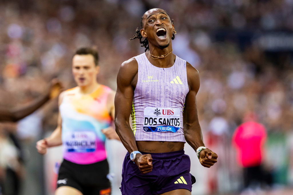 Brazil's Alison dos Santos celebrates winning the men's 400-meter hurdles, setting a new world record, at the Diamond League athletics meeting, Thursday, Aug. 27, 2026, in Zurich, Switzerland. (Jean-Christophe Bott/Keystone via AP)