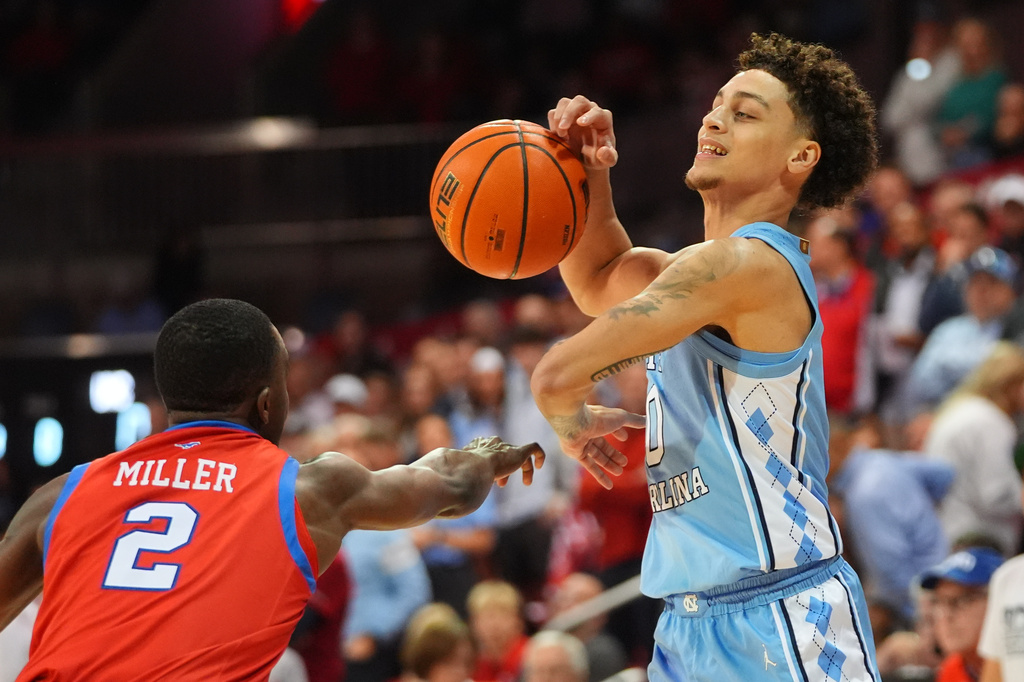 North Carolina guard Kyan Evans (0) looses control of the ball against SMU guard Boopie Miller (2) during the first half of an NCAA college basketball game Saturday, Jan. 3, 2026, in Dallas. (AP Photo/LM Otero)