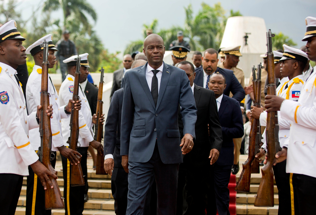 FILE - Haiti's President Jovenel Moise, center, leaves the museum during a ceremony marking the 215th anniversary of revolutionary hero Toussaint Louverture's death, at the National Pantheon museum in Port-au-Prince, Haiti, April 7, 2018. (AP Photo/Dieu Nalio Chery, File)