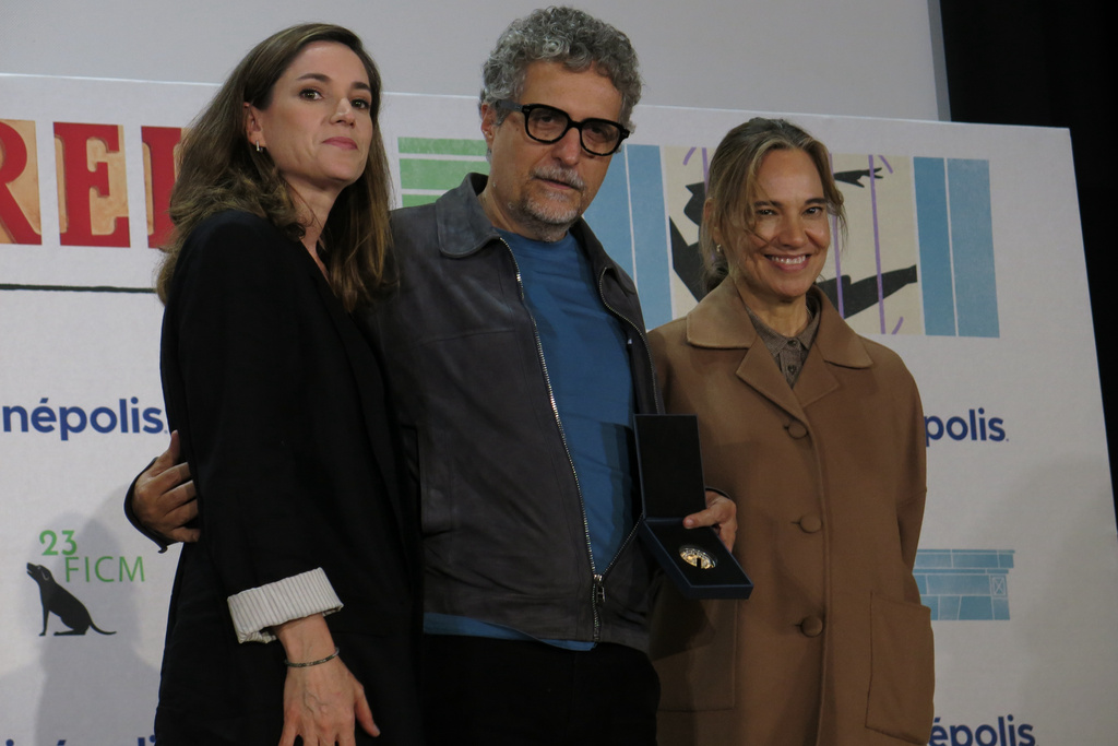 FILE - French producer Emilie Lesclaux, left, Brazilian filmmaker Kleber Mendonça Filho, and and Morelia Film Festival general director Daniela Michel pose for a photo during a news conference at the film "O Agente Secreto" or "The Secret Agent" in Morelia, Mexico, Oct. 10, 2025. (AP Photo/Berenice Bautista, File)