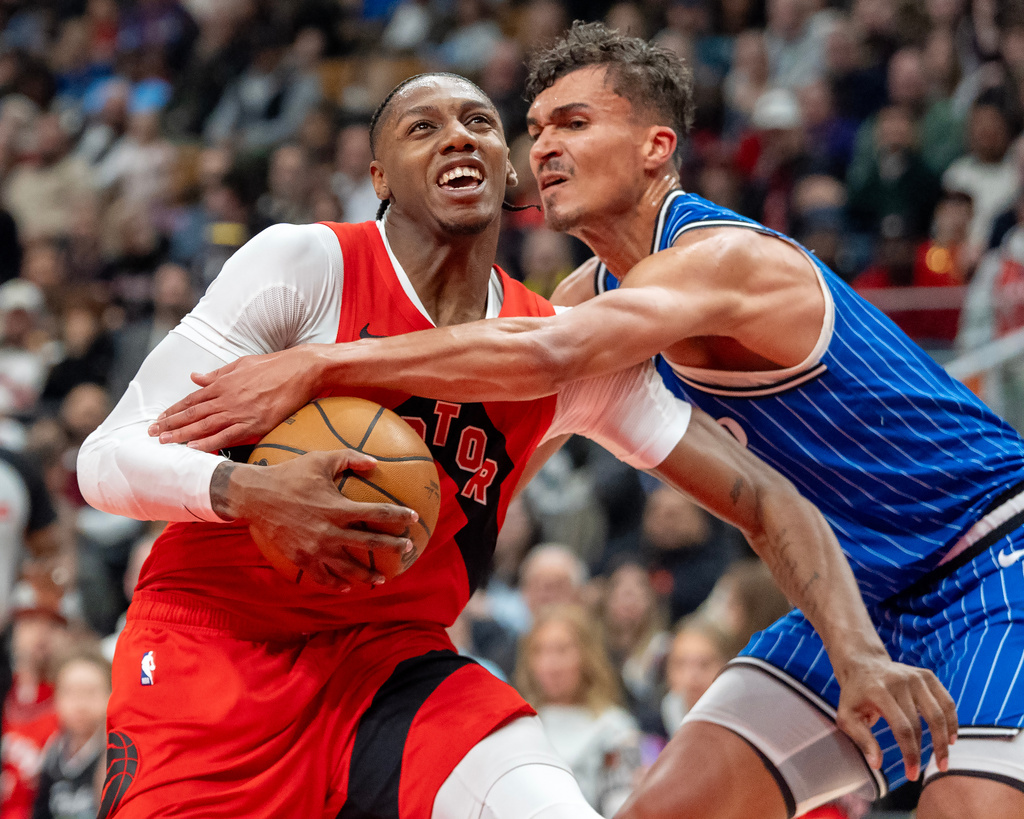 Toronto Raptors forward RJ Barrett (left) is fouled by Orlando Magic forward Tristan da Silva (23) during first half NBA action in Toronto on Sunday, March 29, 2026. (Frank Gunn/The Canadian Press via AP)