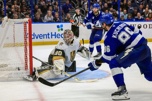 Tampa Bay Lightning's Nikita Kucherov, right, scores against Vegas Golden Knights goaltender Carl Lindbom, left, during the overtime period of an NHL hockey game Sunday, Oct. 26, 2025, in Tampa, Fla. (AP Photo/Mike Carlson) Tampa Bay Lightning's Nikita Kucherov, right, scores against Vegas Golden Knights goaltender Carl Lindbom, left, during the overtime period of an NHL hockey game Sunday, Oct. 26, 2025, in Tampa, Fla. (AP Photo/Mike Carlson)