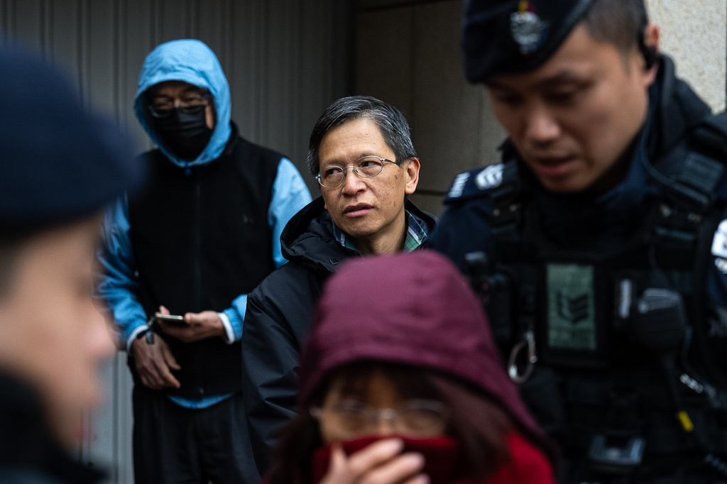 Pro-democracy activist Tang Ngok-kwan waits outside the West Kowloon Magistrates' Courts to attend a trial under a China-imposed national security law on Thursday, Jan. 22, 2026, in Hong Kong. (AP Photo/Chan Long Hei)