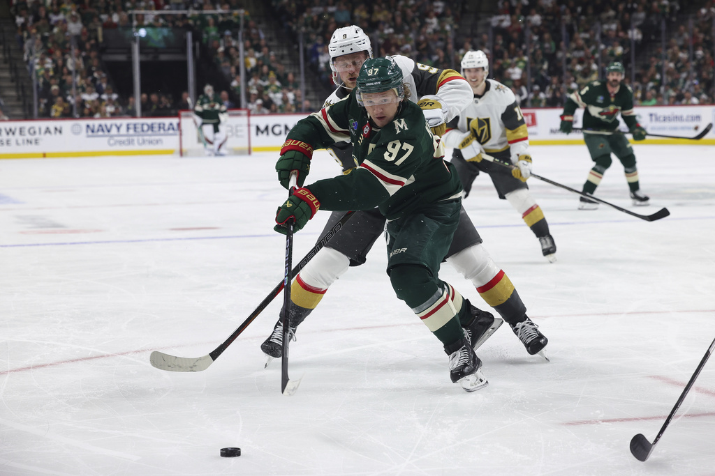 FILE - Minnesota Wild left wing Kirill Kaprizov (97) fights for the puck against Vegas Golden Knights center Jack Eichel (9) during the third period in Game 4 of an NHL hockey Stanley Cup first-round playoff series April 26, 2025, in St. Paul, Minn. Vegas won 4-3 in overtime. (AP Photo/Stacy Bengs, File)