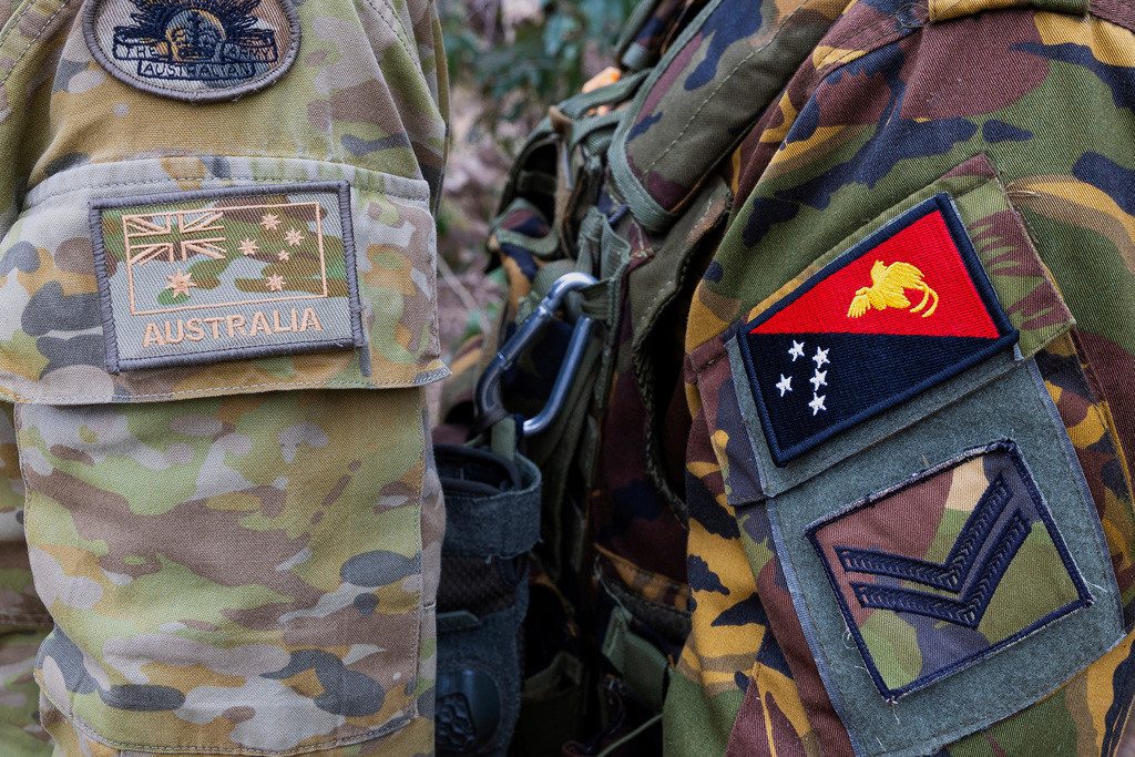 This photo shows the emblem of an Australian Army soldier, left, and a Papua New Guinea Defence Force soldier during an exercise at Talisman Sabre in Townsville, Australia, on July 21, 2025. (LCPL Jessica Gray/Australian Army via AP)