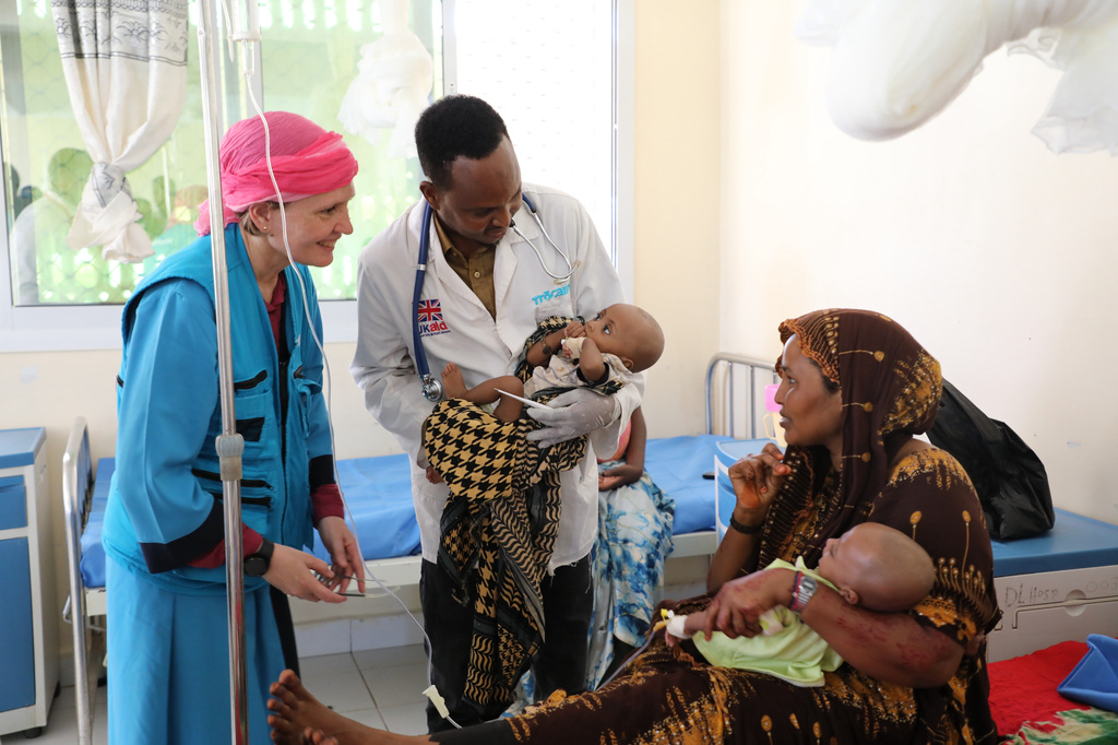 Sandra Lattouf, UNICEF Representative in Somalia, smiles at a mother of twin malnourished children at Dolow Referral Hospital in southern Somalia, Wednesday, March 25, 2026.(AP Photo/Mohamed Sheikh Nor)