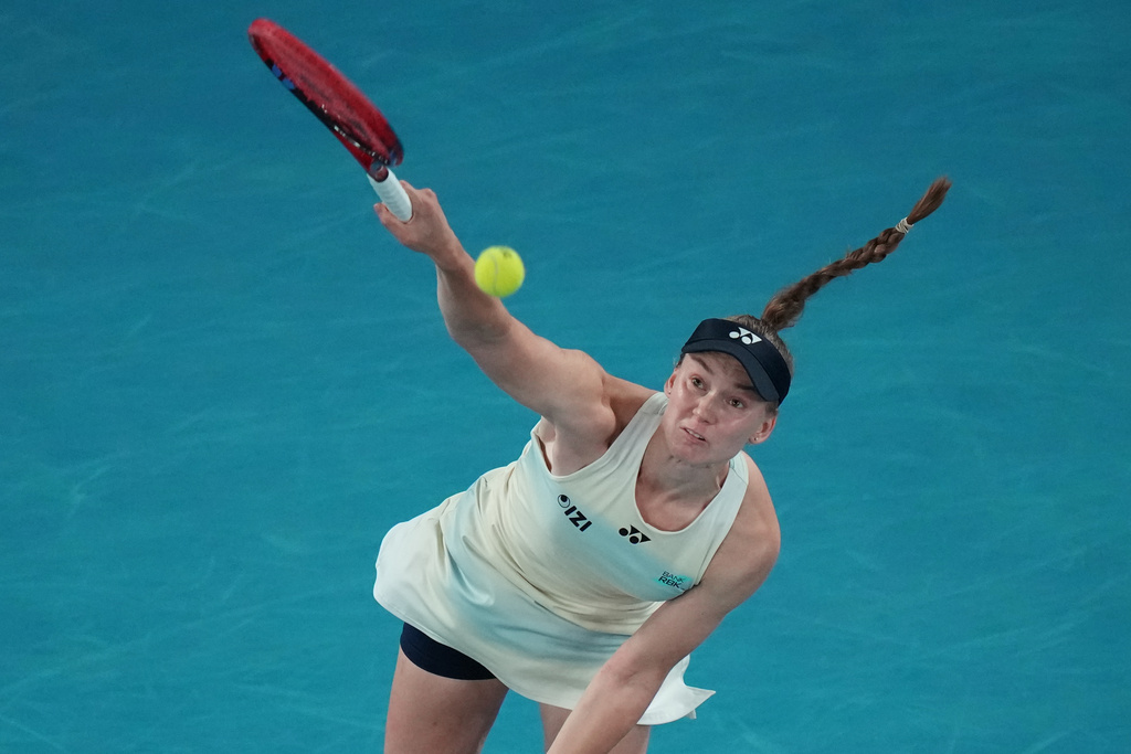 Elena Rybakina of Kazakhstan serves the ball to Aryna Sabalenka of Belarus during the women's singles final at the Australian Open tennis championship in Melbourne, Australia, Saturday, Jan. 31, 2026. (AP Photo/Dar Yasin)