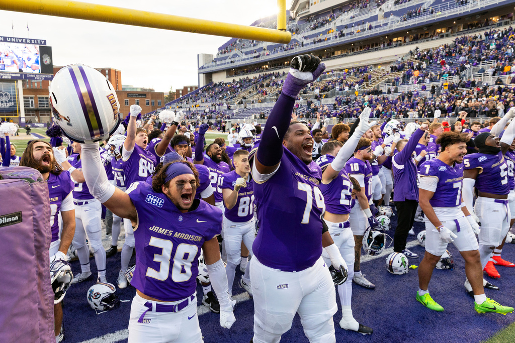 James Madison players celebrate defeating Washington State in an NCAA college football game, Saturday, Nov. 22, 2025, in Harrisonburg, Va. (AP Photo/Ryan M. Kelly)