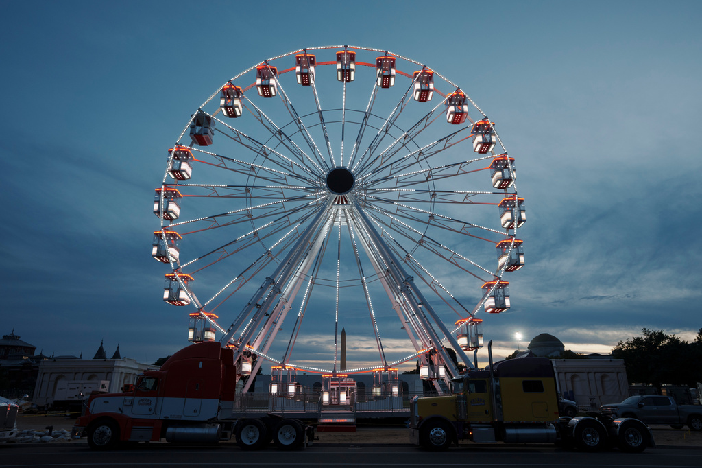 The ferris wheel on the National Mall is lit as preparation continues for the Great American State Fair on the National Mall, Sunday, June 21, 2026, in Washington. (AP Photo/Jon Elswick
