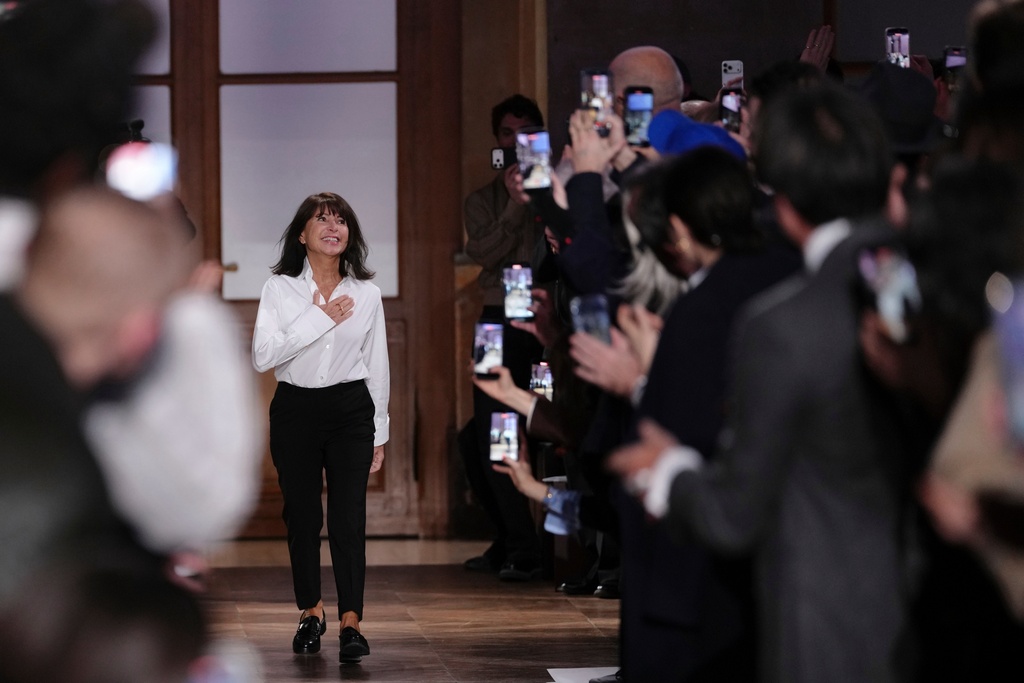 Designer Veronique Nichanian accepts applause after the Hermes Fall/Winter 2026-2027 Men's collection presented in Paris, Saturday, Jan. 24, 2026. (AP Photo/Aurelien Morissard)