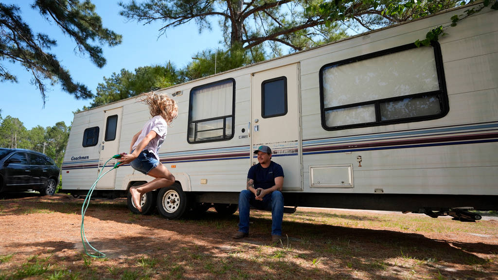Annabelle Enke plays as her father Michael Gibson looks on after losing thier home at the Brantley Highway 82 fire, Friday, April 24, 2026, in Nahunta, Ga. (AP Photo/Mike Stewart)