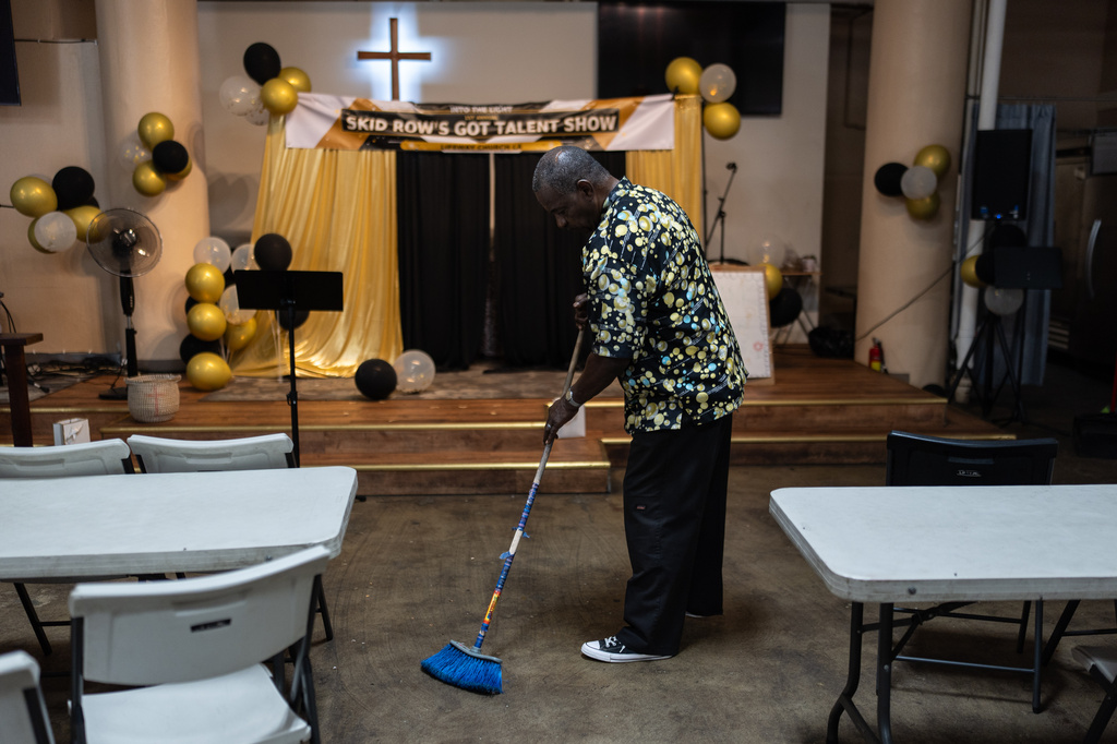 Rev. Gary Carr sweeps the floor at Lifeway Church after Skid Row's inaugural talent show in downtown Los Angeles, Saturday, Sept. 19, 2026. (AP Photo/Jae C. Hong)
