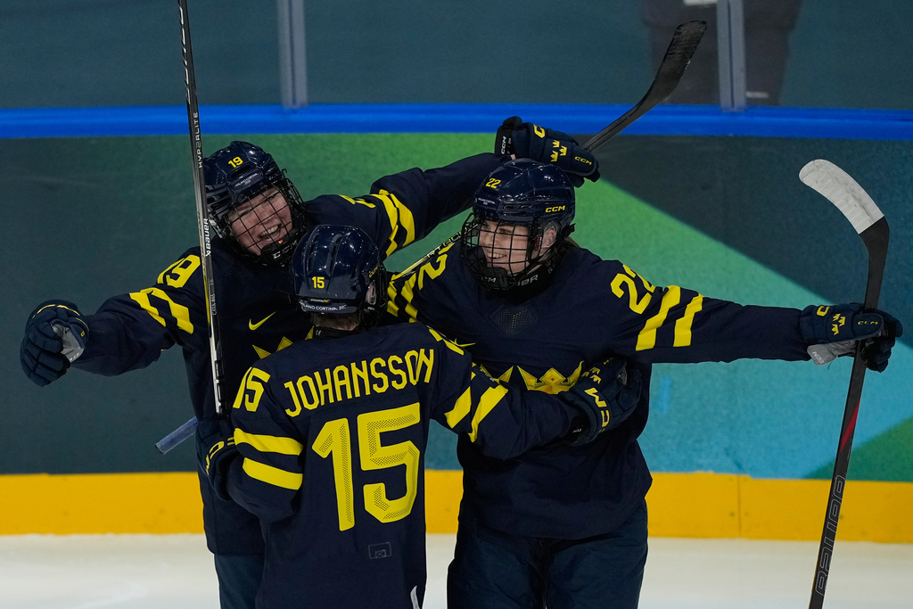Sweden's Hanna Thuvik, right, celebrates after scoring her side's opening goal during a preliminary round match of women's ice hockey between Japan and Sweden at the 2026 Winter Olympics, in Milan, Italy, Tuesday, Feb. 10, 2026. (AP Photo/Hassan Ammar)