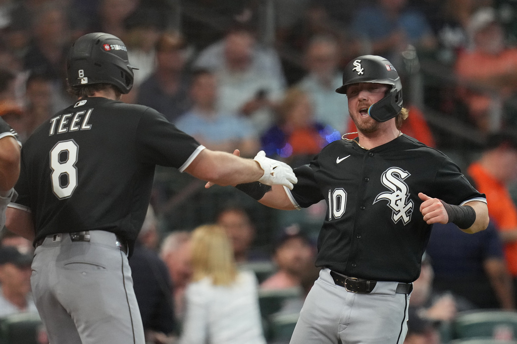 Chicago White Sox's Chase Meidroth (10) celebrates with Kyle Teel (8) after scoring off a 2-run single hit by by Sam Antonacci during the second inning in Game 1 of baseball's American League Wild Card Series against the Houston Astros, Tuesday, Sept. 29, 2026, in Houston. (AP Photo/Karen Warren)