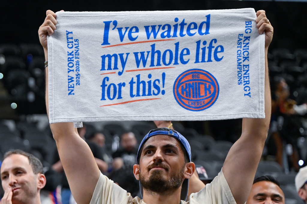 A New York Knicks fan celebrates after the Knicks defeated the San Antonio Spurs in Game 5 of the NBA Finals basketball series, Saturday, June 13, 2026, in San Antonio. (AP Photo/Darren Abate)