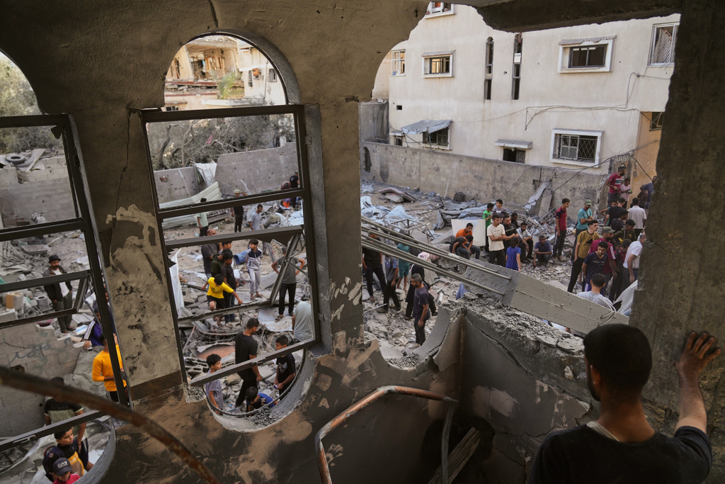 Palestinians survey the aftermath of an Israeli military strike on the Abu Dahrouj family home in Zawaida, central Gaza Strip, Thursday, Sept. 25, 2025. (AP Photo/Abdel Kareem Hana)