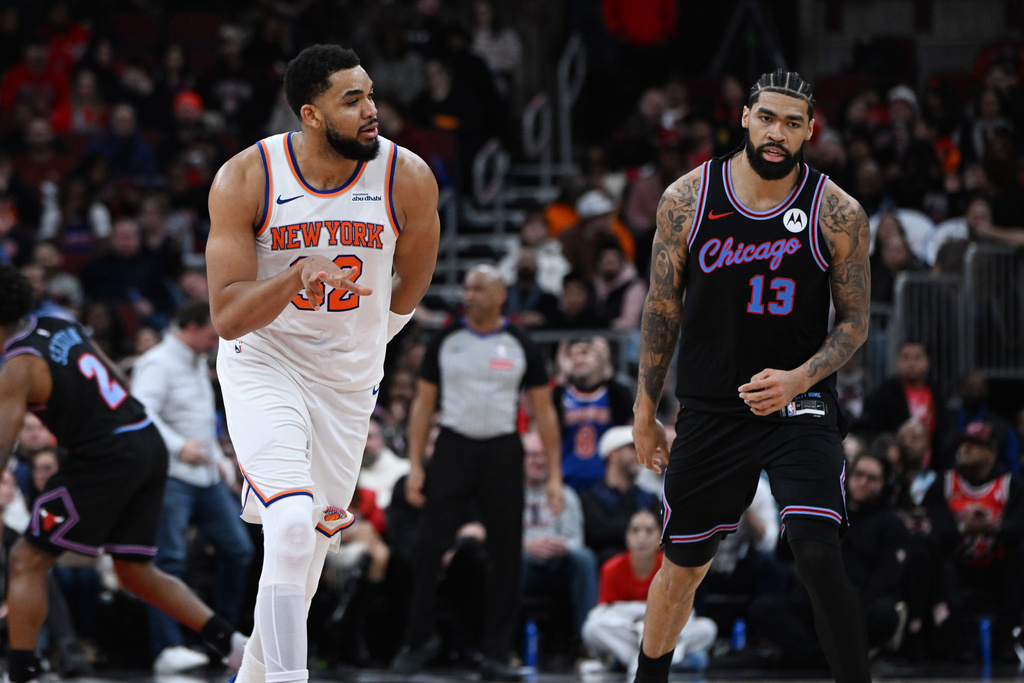 New York Knicks' Karl-Anthony Towns (32) celebrates after making a 3-point basket while Chicago Bulls' Nick Richards (13) reacts during the second half of an NBA basketball game, Sunday, Feb. 22, 2026, in Chicago. (AP Photo/Paul Beaty)