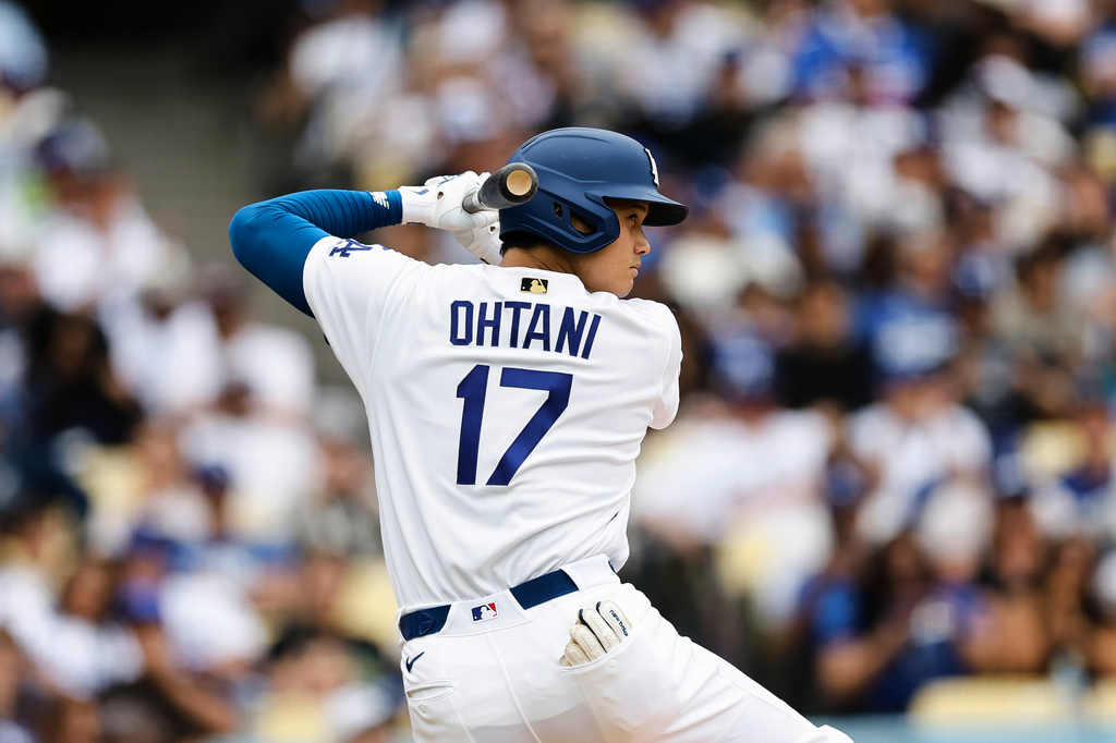 Los Angeles Dodgers designated hitter Shohei Ohtani (17) practices his swing while on deck during the fifth inning of a baseball game against the Texas Rangers, Sunday, April 12, 2026, in Los Angeles. (AP Photo/Caroline Brehman)
