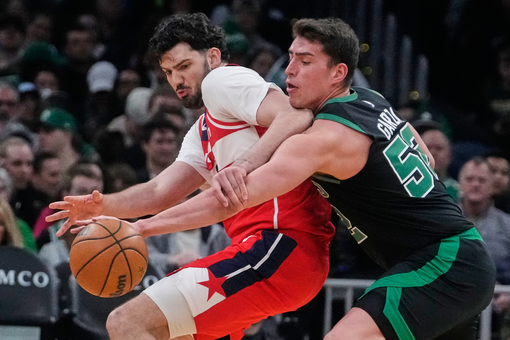 Boston Celtics center Luka Garza, right, steals the ball from Washington Wizards forward Tristan Vukcevic, left, during the first half of an NBA basketball game, Saturday, March 14, 2026, in Boston. (AP Photo/Charles Krupa)
