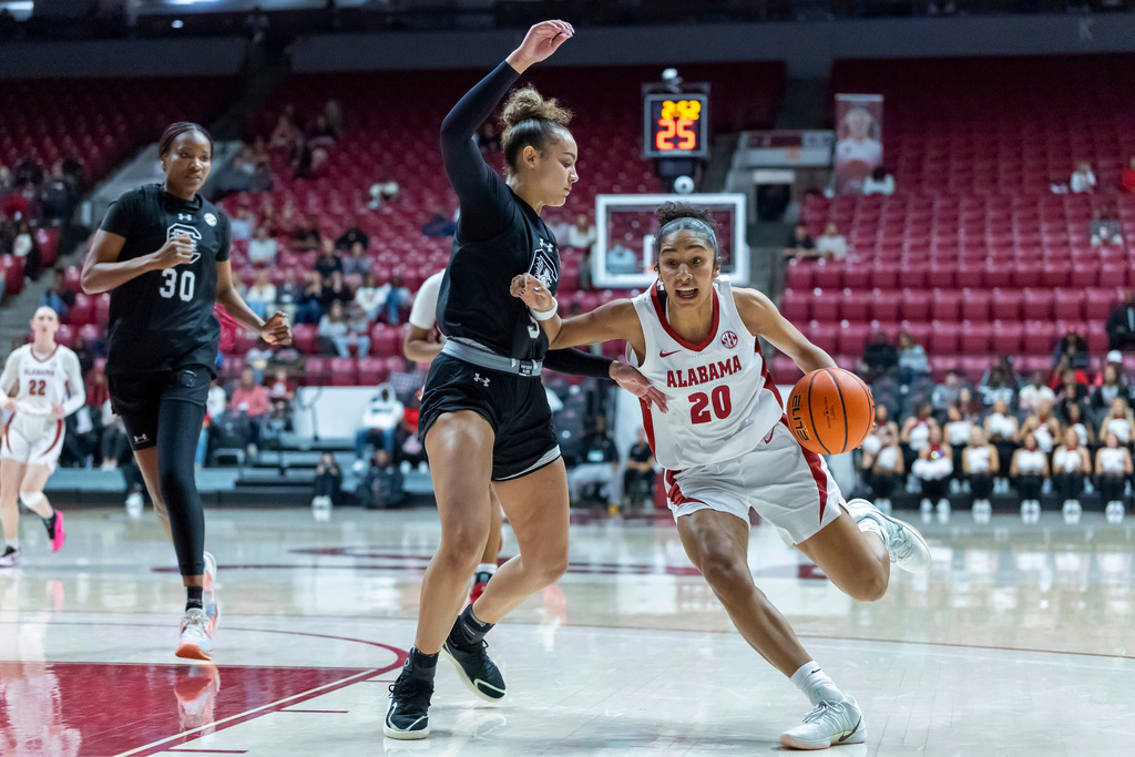 Alabama guard Diana Collins (20) works inside against South Carolina guard Tessa Johnson, second from right, during the first half of an NCAA college basketball game Thursday, Feb. 19, 2026, in Tuscaloosa, Ala. (AP Photo/Vasha Hunt)