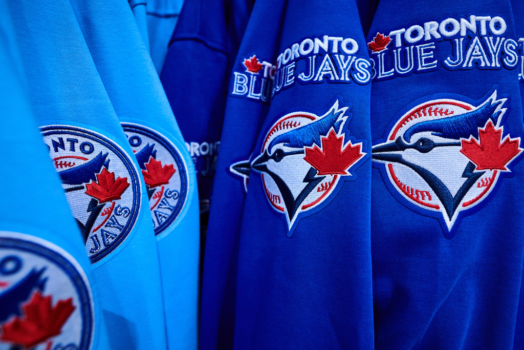 Toronto Blue Jays jerseys are on display at a merchandise store outside Rogers Centre in Toronto, Saturday, Oct. 11, 2025. (Sammy Kogan/The Canadian Press via AP)