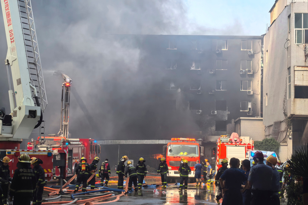In this photo released by Xinhua News Agency, firefighters at the scene of a footwear factory fire in Jiangtou village, Chendai township of Jinjiang city, southeastern China's Fujian province, Thursday, July 9, 2026. (Zheng Liang/Xinhua via AP)