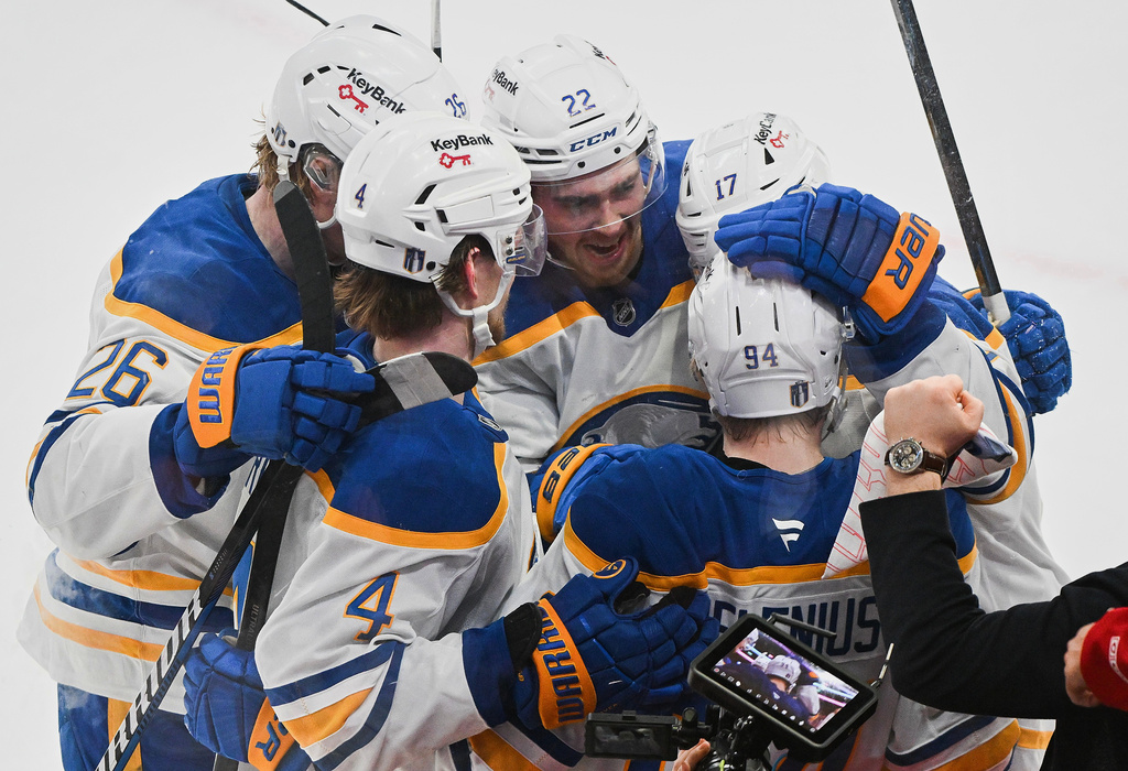 Buffalo Sabres' Konsta Helenius (94) celebrates with teammates after scoring against the Montreal Canadiens during the second period of Game 6 in a second-round NHL hockey Stanley Cup playoff series in Montreal, Saturday, May 16, 2026. (Graham Hughes/The Canadian Press via AP)