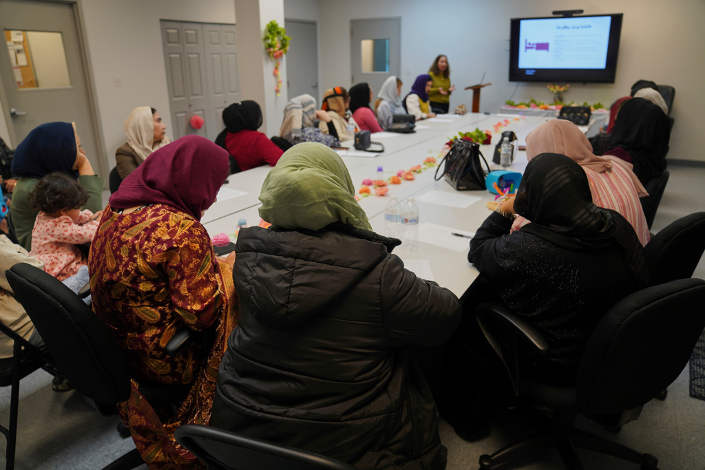FILE - A group of female Afghan refugees gather for a class on self-care and a post-Ramadan celebration at Catholic Charities Migrant and Refugee Services office in Fredericksburg, Va., on Tuesday, April 8, 2025. (AP Photo/Jessie Wardarski, File)