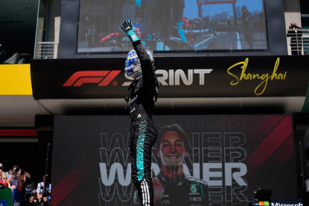 Mercedes driver George Russell of Britain waves after winning the Sprint Race of the Chinese Formula One Grand Prix at the Shanghai International Circuit, in Shanghai, China, Saturday, March 14, 2026. (AP Photo/Andy Wong)