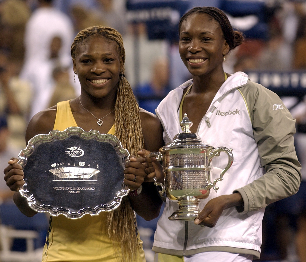 FILE - Venus Williams right, and her sister, Serena, pose with their trophies after their U.S. Open womens singles final in New York Saturday Sept. 8, 2001.Venus defeated Serena 6-2, 6-4. (AP Photo/Amy Sancetta, file)