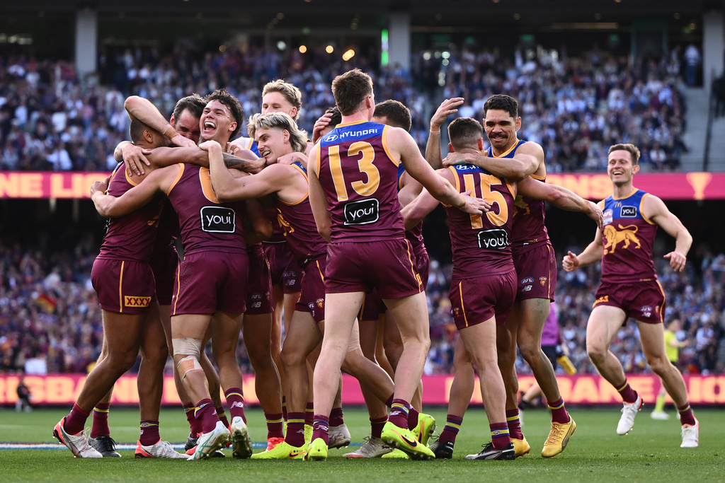 Hugh McCluggage of the Lions celebrates scoring a goal with teammates during the AFL Grand Final between the Geelong Cats and the Brisbane Lions at the Melbourne Cricket Ground in Melbourne, Saturday, Sept. 27, 2025. (Joel Carrett/AAP Image via AP)