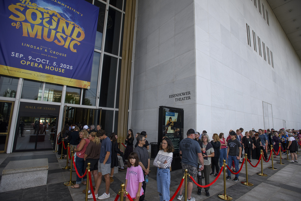 People wait in line for a memorial and prayer vigil for Charlie Kirk at the John F. Kennedy Memorial Center for the Performing Arts, Sunday, Sept. 14, 2025, in Washington. (AP Photo/Rod Lamkey, Jr.)