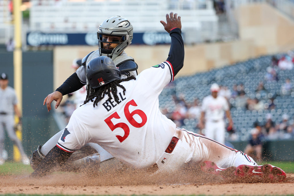 Chicago White Sox catcher Edgar Quero, top, tags out Minnesota Twins' Josh Bell (56) at home plate during the fourth inning of a baseball game, Monday, June 1, 2026, in Minneapolis. (AP Photo/Matt Krohn)
