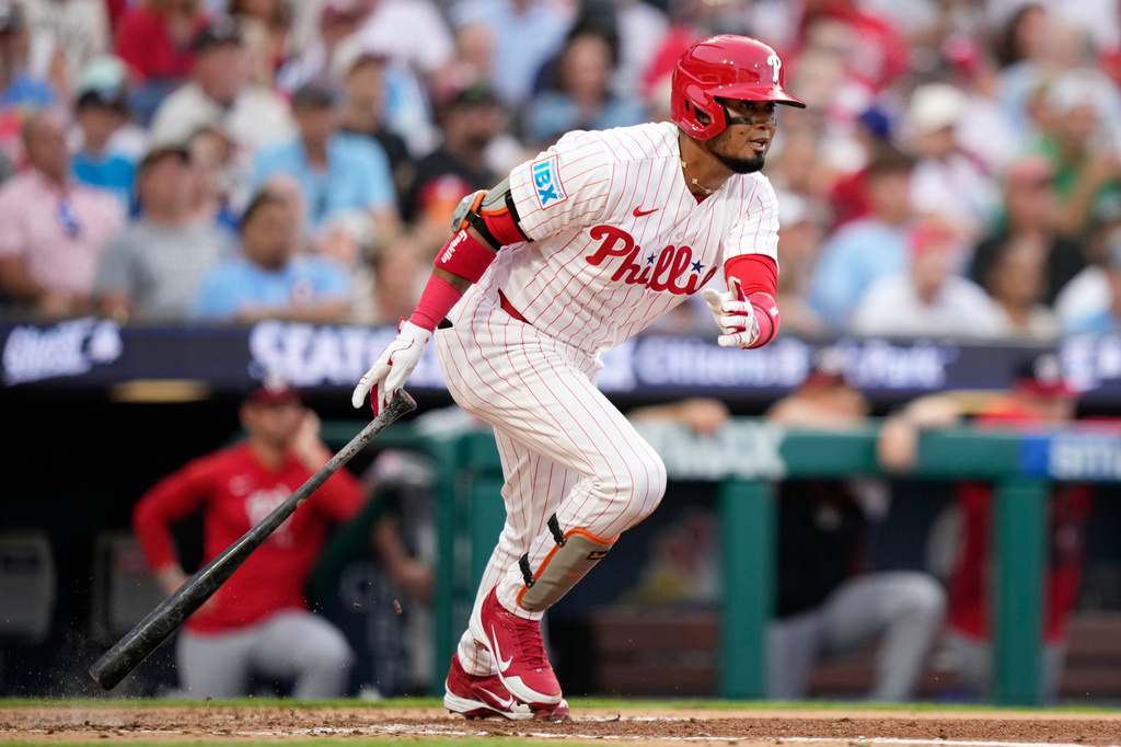 Philadelphia Phillies' Luis Arraez follows through after hitting a run-scoring double against Washington Nationals pitcher Zack Littell during the third inning of a baseball game Tuesday, Aug. 4, 2026, in Philadelphia. (AP Photo/Matt Slocum)