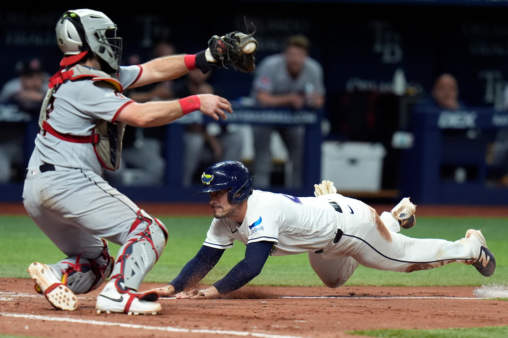 Tampa Bay Rays' Nick Fortes, right, scores ahead of the tag by Cleveland Guardians catcher Austin Hedges on an RBI single by Junior Caminero during the sixth inning of a baseball game Friday, July 24, 2026, in St. Petersburg, Fla. (AP Photo/Chris O'Meara)