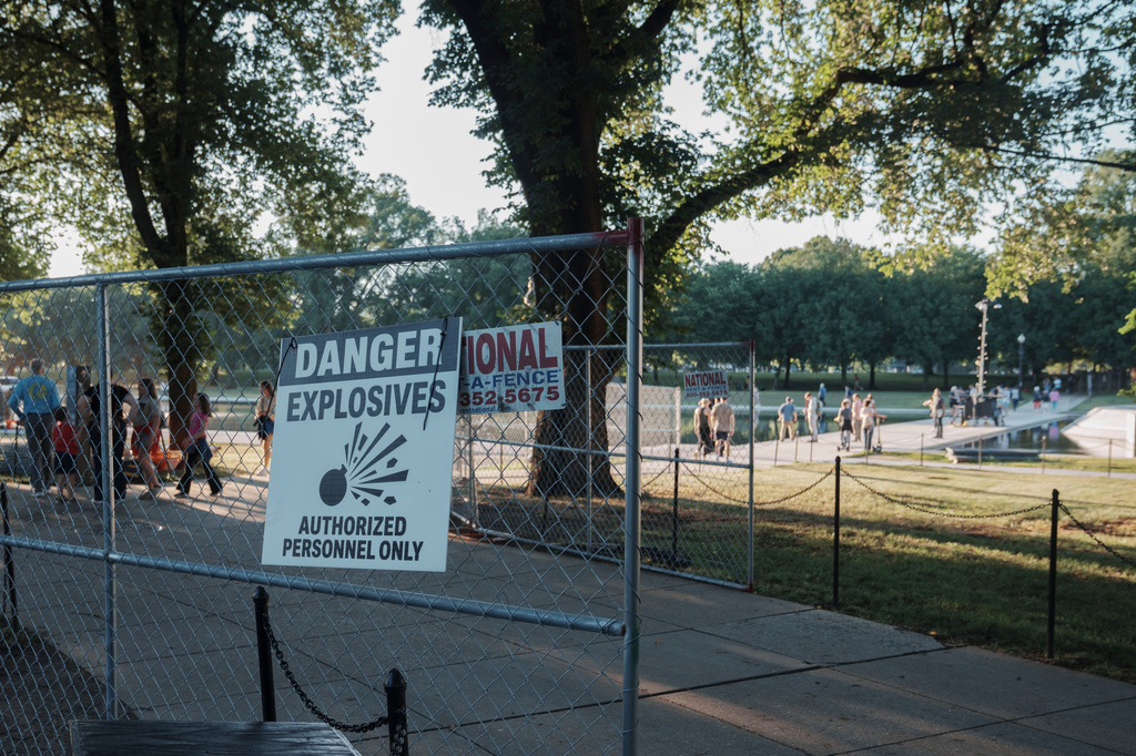 Fencing that will secure an area around where fireworks for the Fourth of July will be launched is seen near the Lincoln Memorial Reflecting Pool and the World War II Memorial Tuesday, June 23, 2026, in Washington. (AP Photo/Jon Elswick)