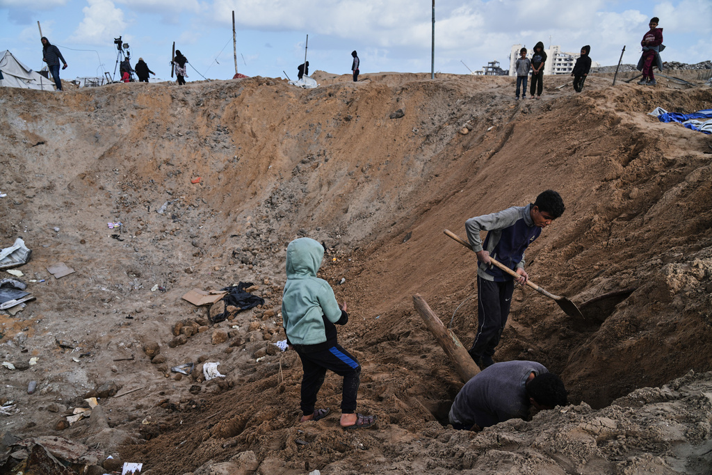 Palestinians inspect the damage at a displacement camp following an Israeli strike in Gaza City, Friday, Jan. 9, 2026. (AP Photo/Jehad Alshrafi)