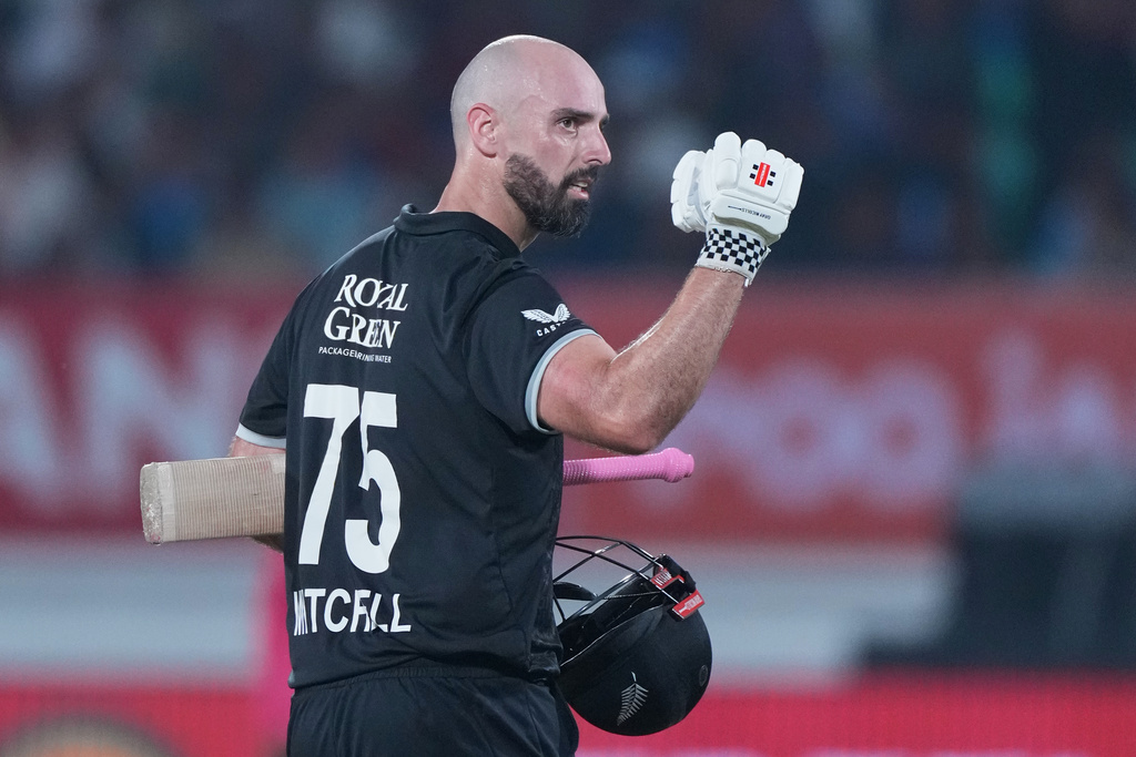 New Zealand's Daryl Mitchell celebrates after scoring a century during the second One Day International cricket match between India and New Zealand in Rajkot, India, Wednesday, Jan. 14, 2026. (AP Photo/Ajit Solanki)