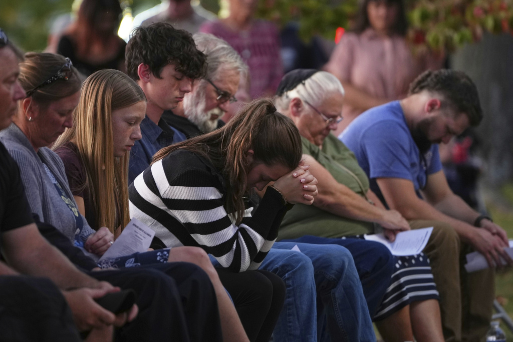 Attendees react during a vigil at Spring Grove Alliance church Thursday, Sept. 18, 2025, in Spring Grove, Pa., after multiple police officers were shot and killed. (AP Photo/Matt Slocum)