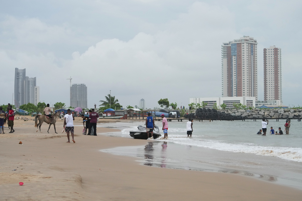 Beachgoers play at Takwa Bay beach in Lagos, Nigeria, Sunday, June 28, 2026. (AP Photo/Sunday Alamba)